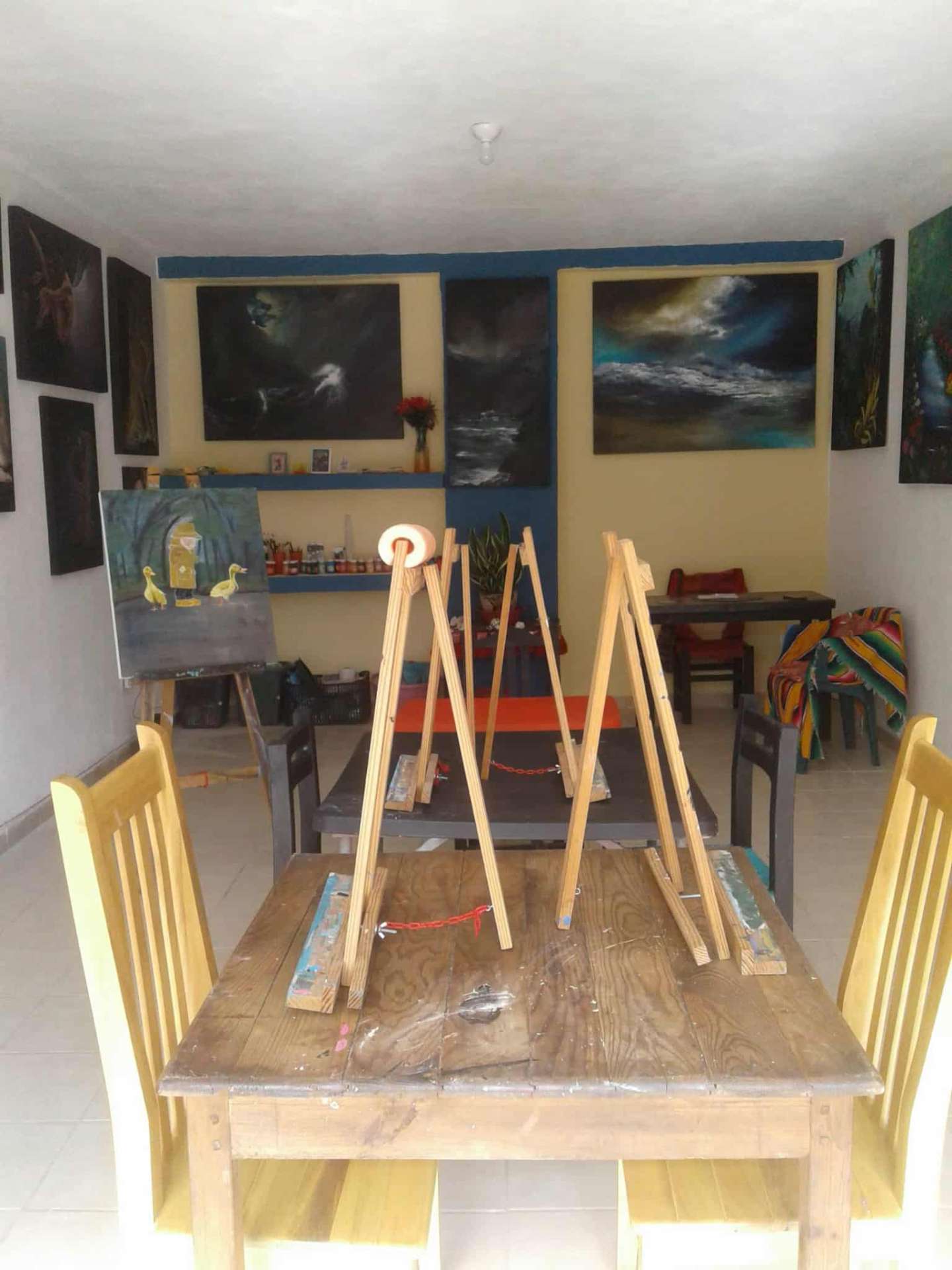 The studio filled with paintings and easels